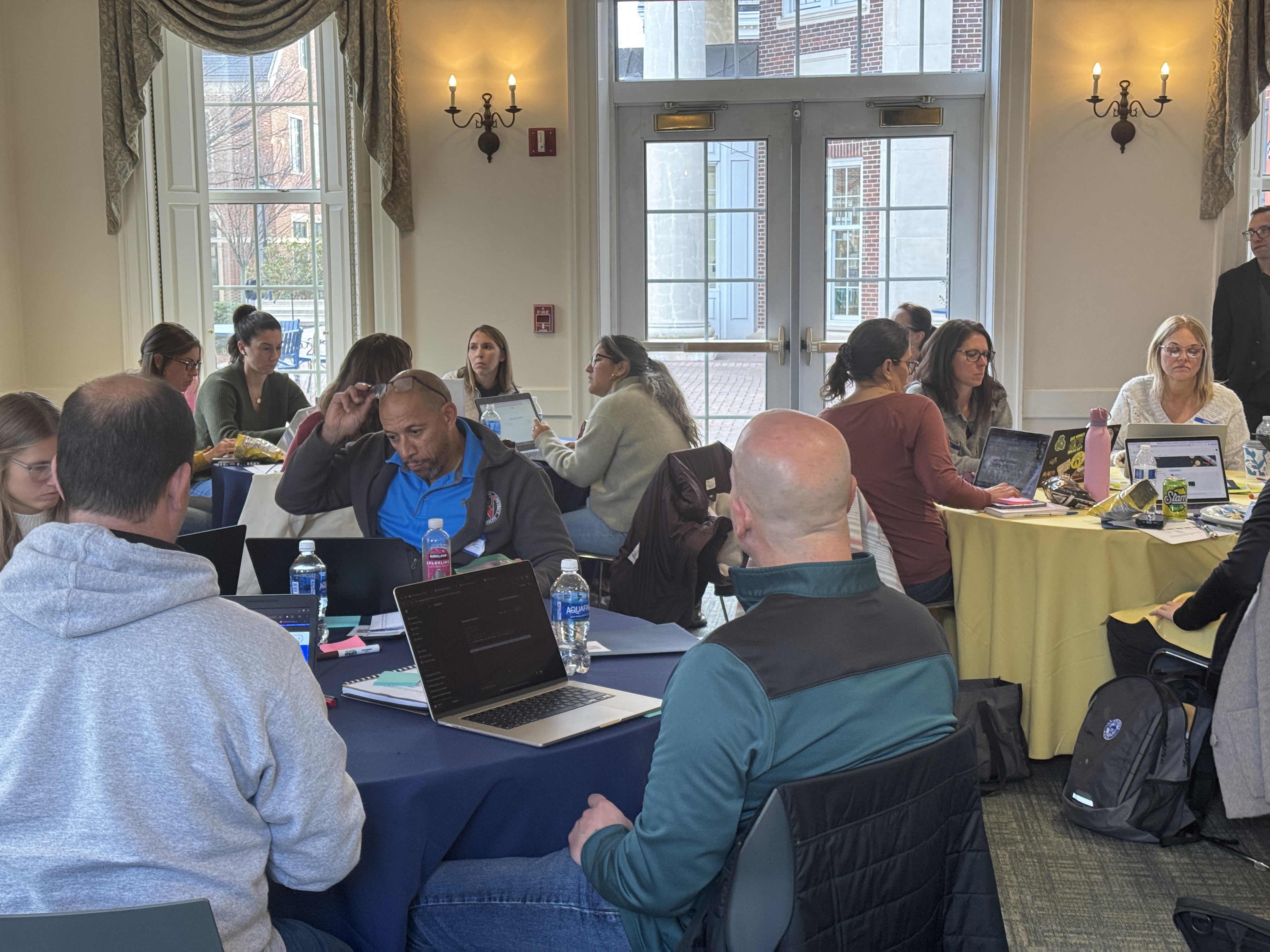Teachers working independently on their own AI apps in Google AI Studio
